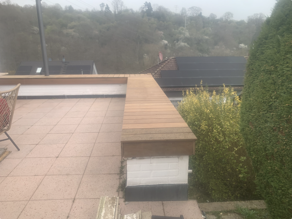 Durchgehende Sitzkante aus Ipe Holz auf bestehenden Pflanzkästen entlang des Terrassenrands in Bad Soden